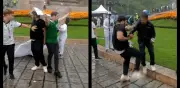 VIDEO: Aficionados usan lona de desaparecidos para cubrirse de la lluvia en el Ángel